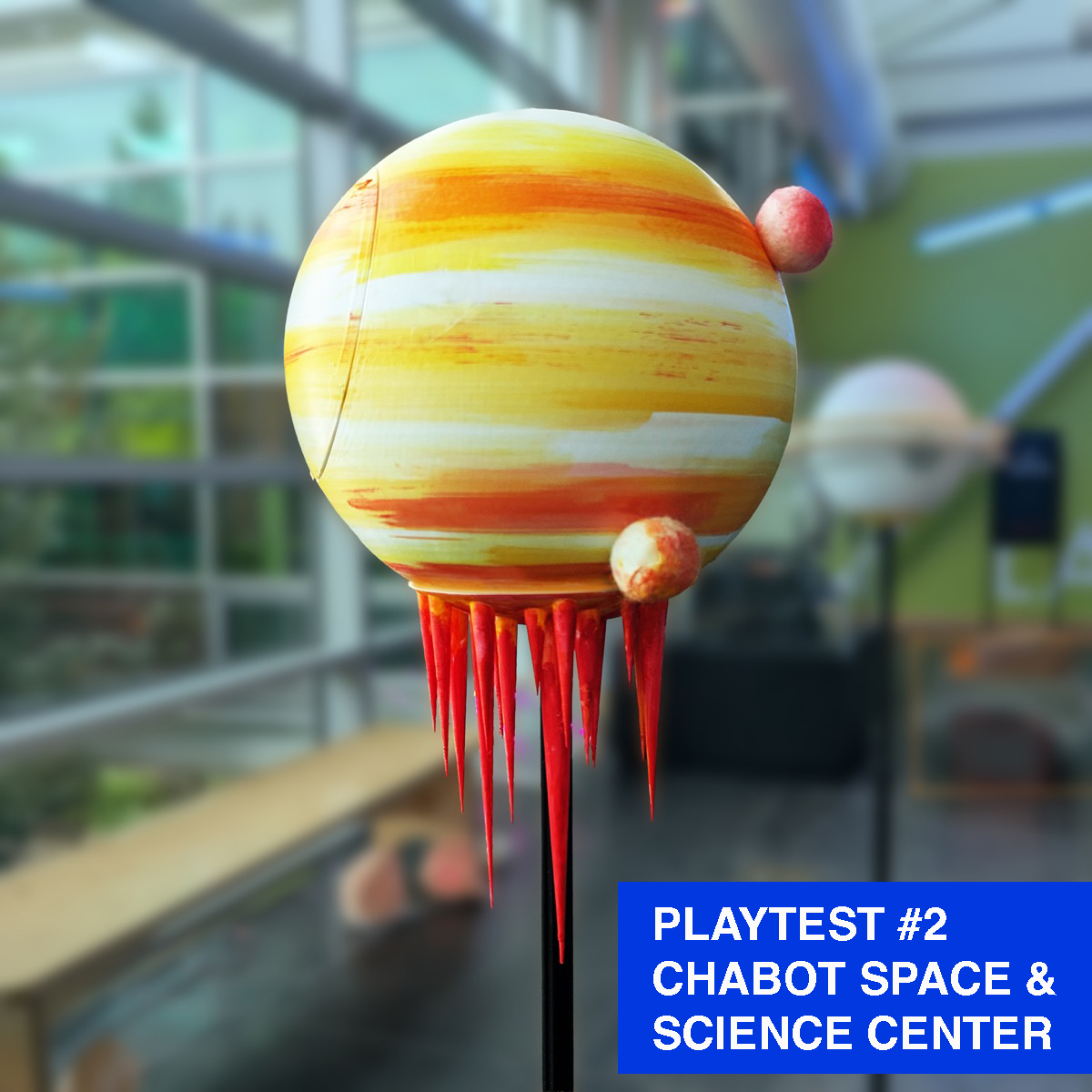 A planet sculpture that has 2 moons